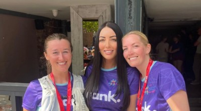 The Frank team wearing branded t-shirts, in the sunshine, smiling at the camera