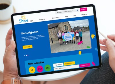 CNWL Shine charity website shown on an iPad screen
