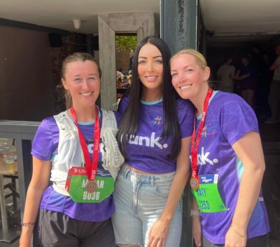 The Frank team wearing branded t-shirts, in the sunshine, smiling at the camera