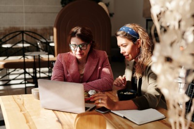Two women looking at a laptop screen together